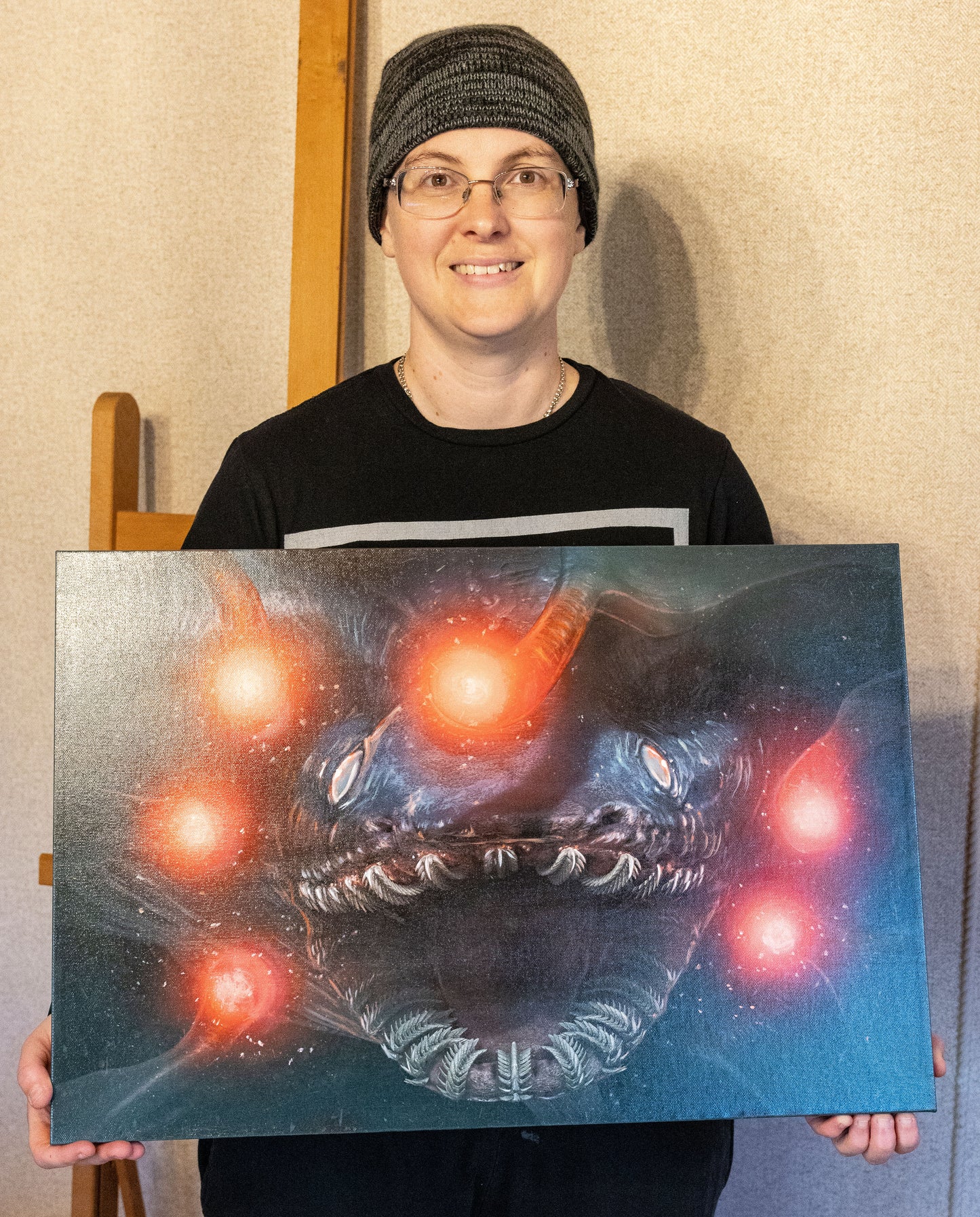 Sarah Dahlinger poses with the embellished canvas.